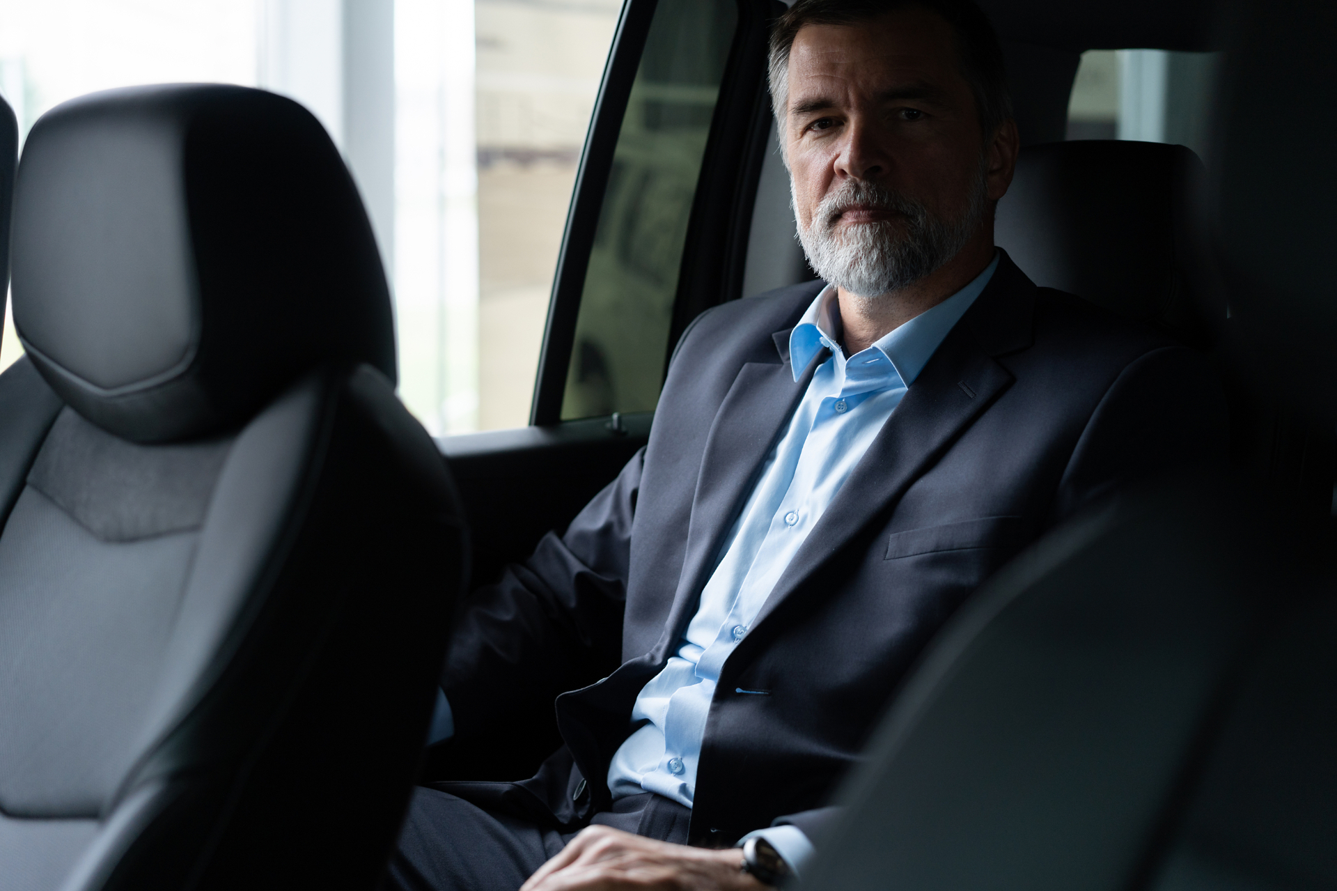 Successful business owner exiting a luxury vehicle
